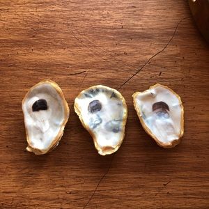3 gold rimmed and glossed oyster shells.